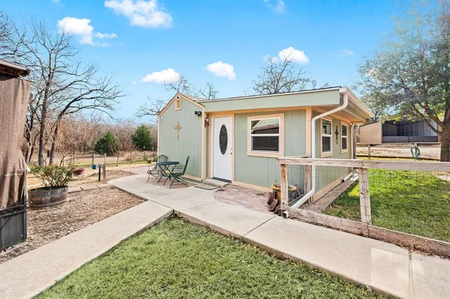 a view of a house with backyard porch and sitting area