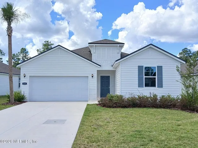 a view of a house with a backyard