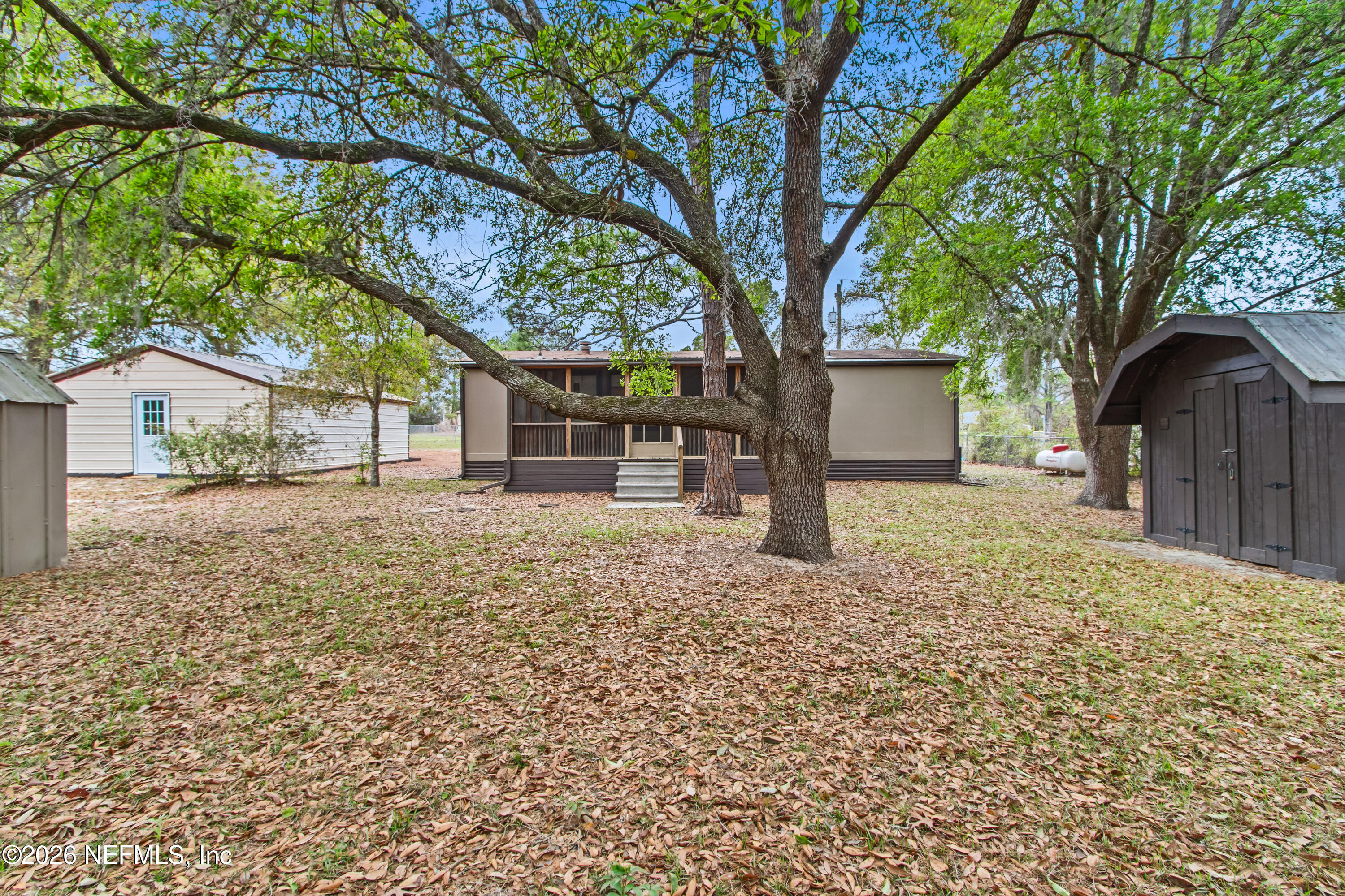 206 Anthony Avenue Interlachen, FL 32148 - Photo 11 of 32 a house with trees in front of it