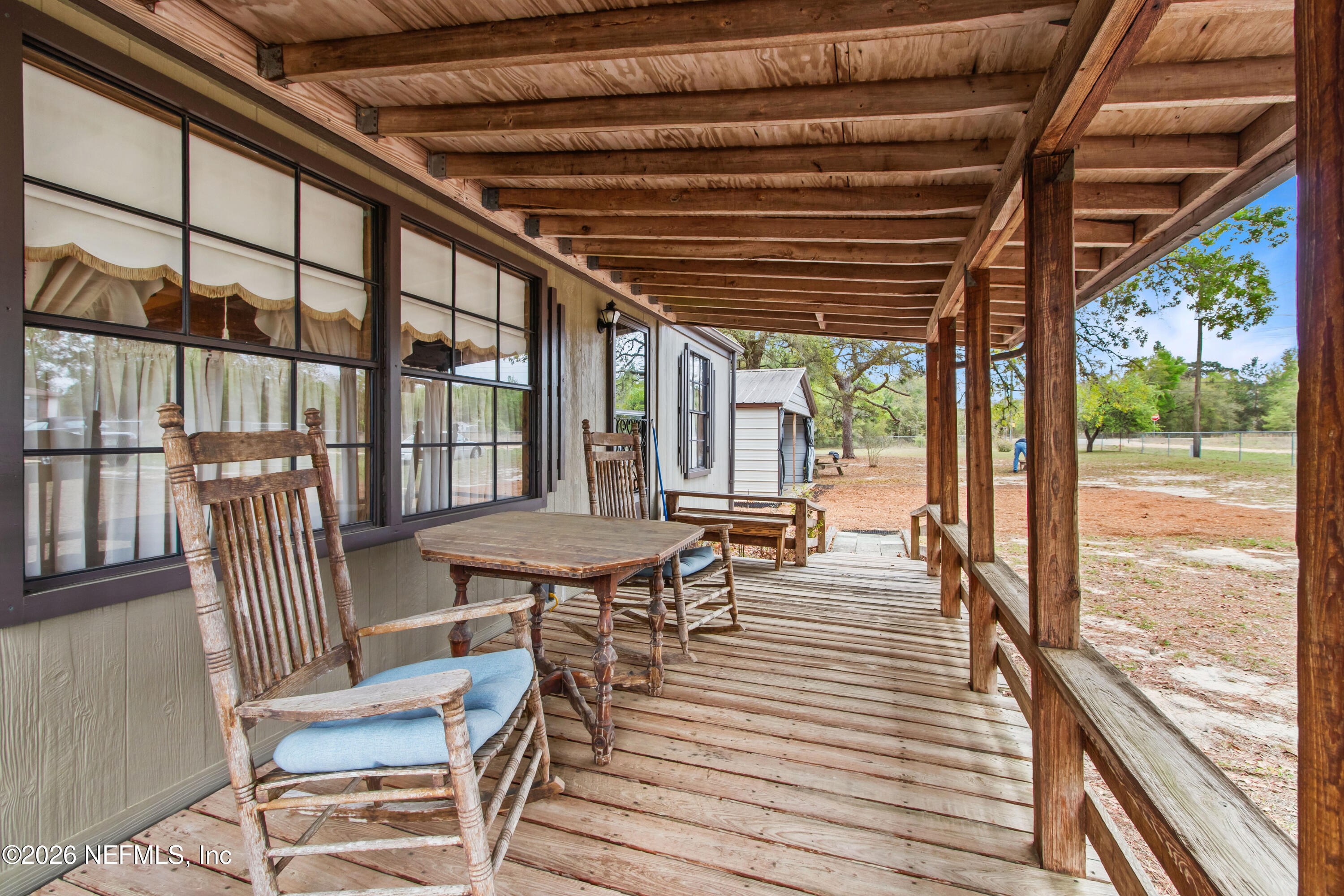 206 Anthony Avenue Interlachen, FL 32148 - Photo 13 of 32 a view of a patio with a table chairs and wooden floor