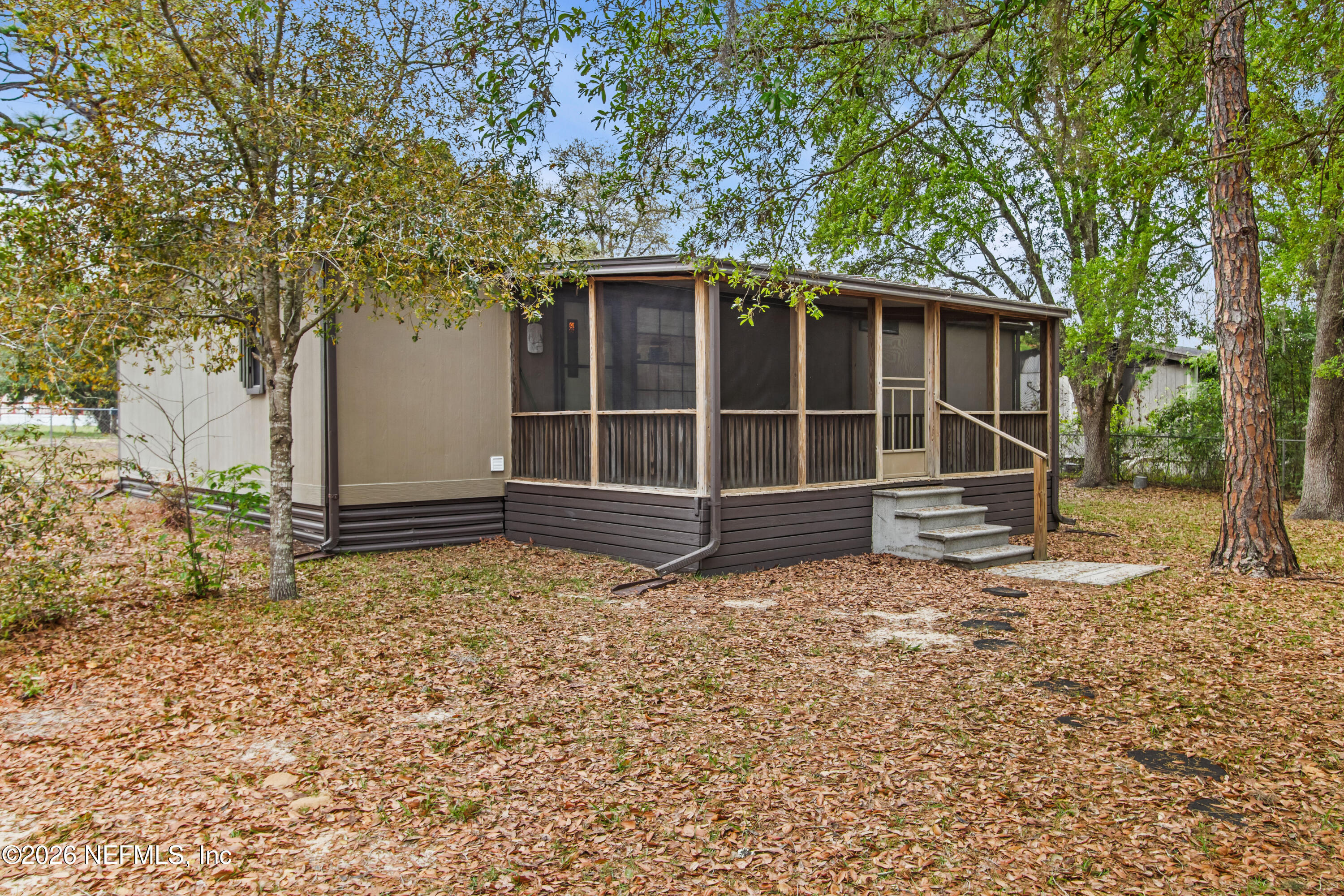 206 Anthony Avenue Interlachen, FL 32148 - Photo 2 of 32 a house with trees in front of it