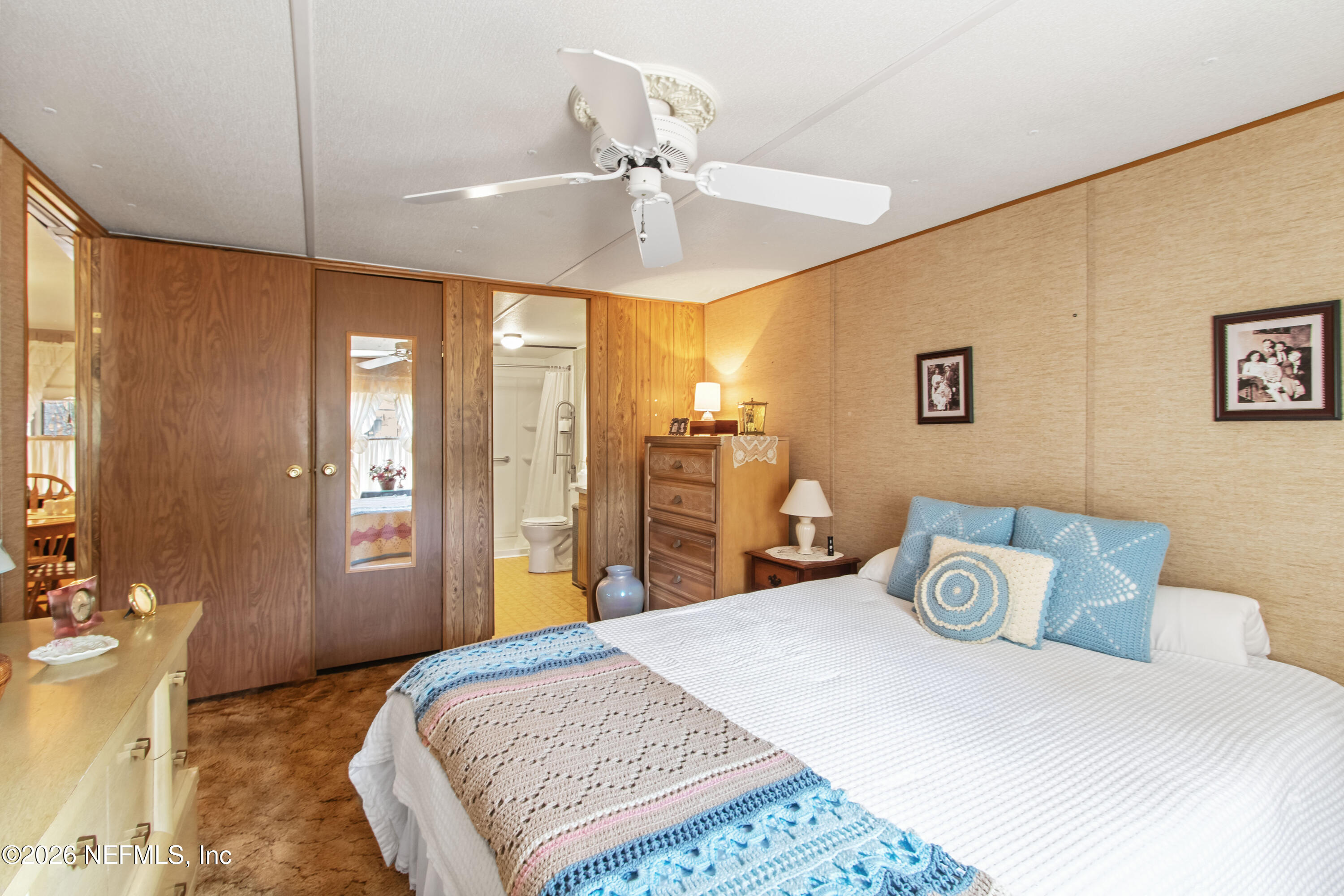 206 Anthony Avenue Interlachen, FL 32148 - Photo 27 of 32 a bedroom with a bed and ceiling fan