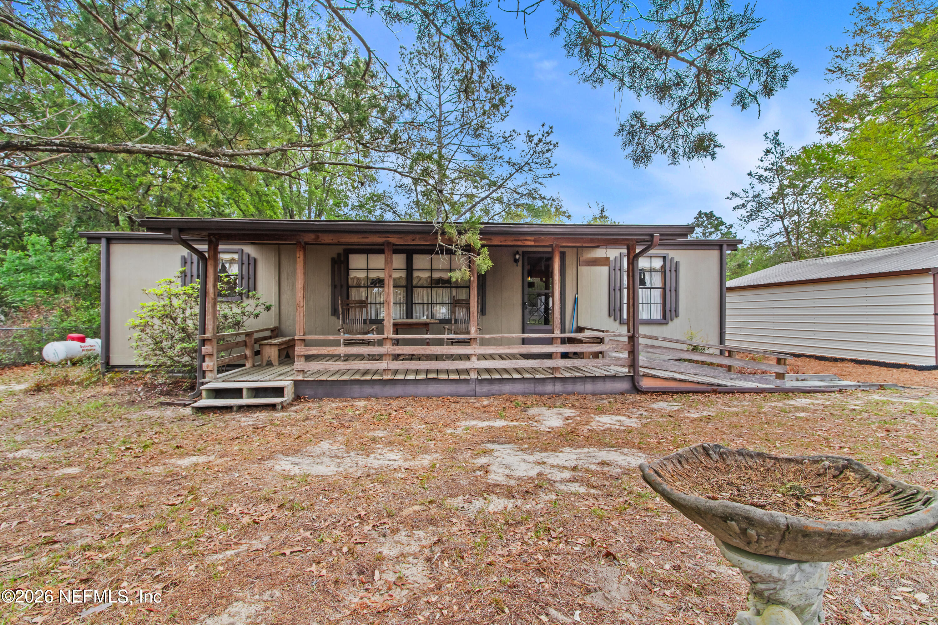 206 Anthony Avenue Interlachen, FL 32148 - Photo 29 of 32 a backyard of a house with barbeque oven