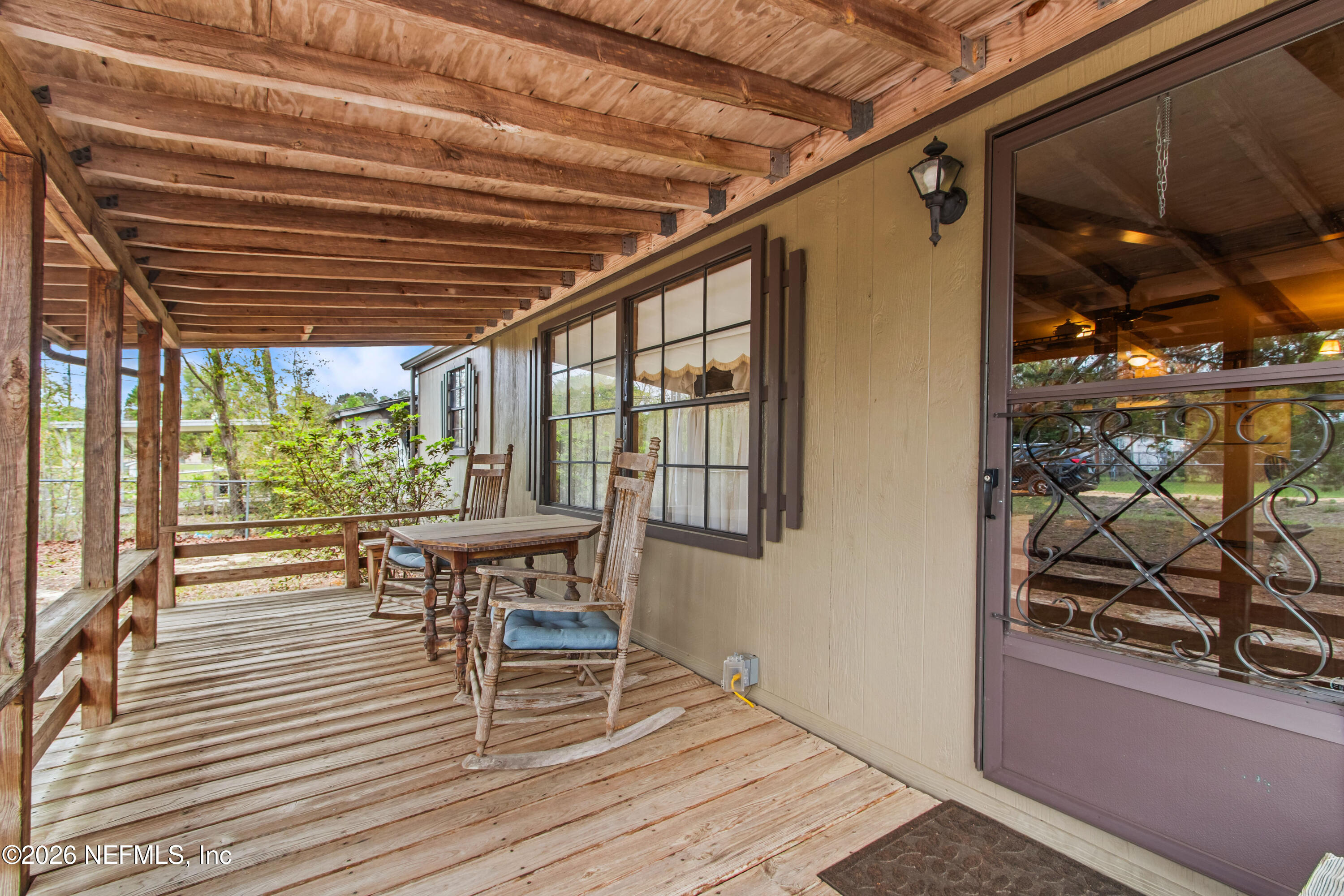 206 Anthony Avenue Interlachen, FL 32148 - Photo 3 of 32 a view of a patio with table and chairs with wooden floor and plants