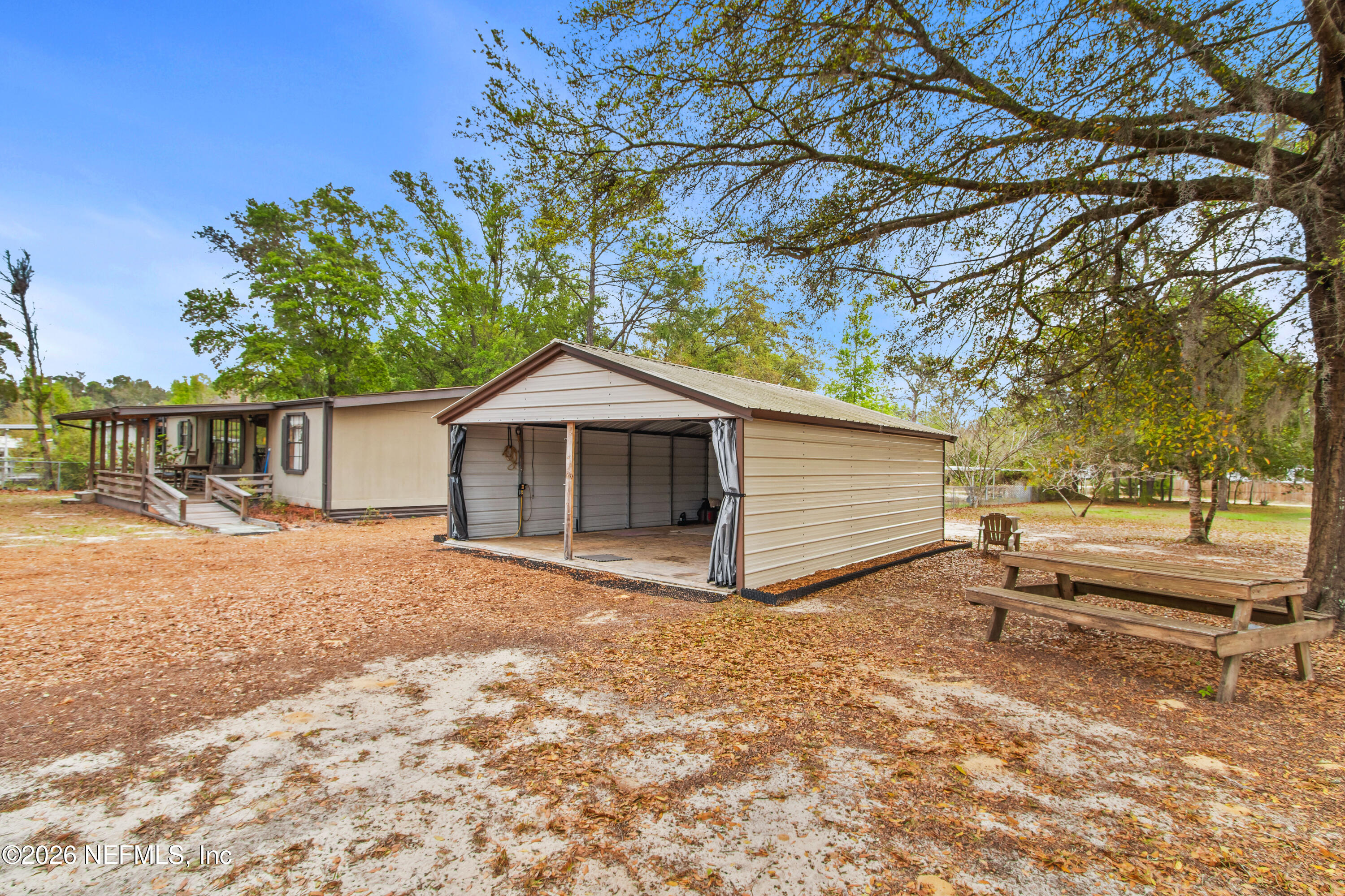 206 Anthony Avenue Interlachen, FL 32148 - Photo 7 of 32 a wooden house with trees in front of it