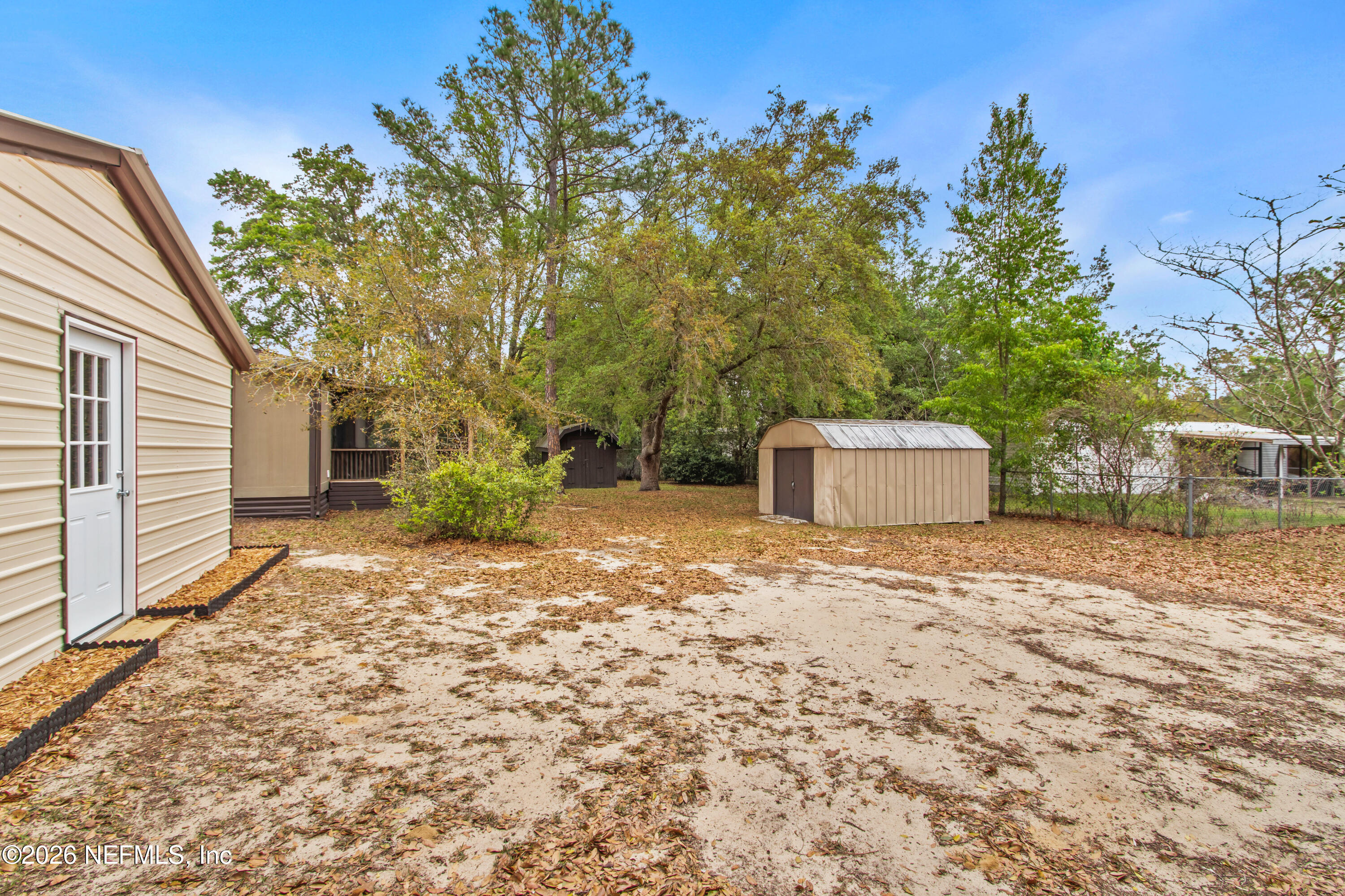 206 Anthony Avenue Interlachen, FL 32148 - Photo 9 of 32 a backyard of a house with a tree