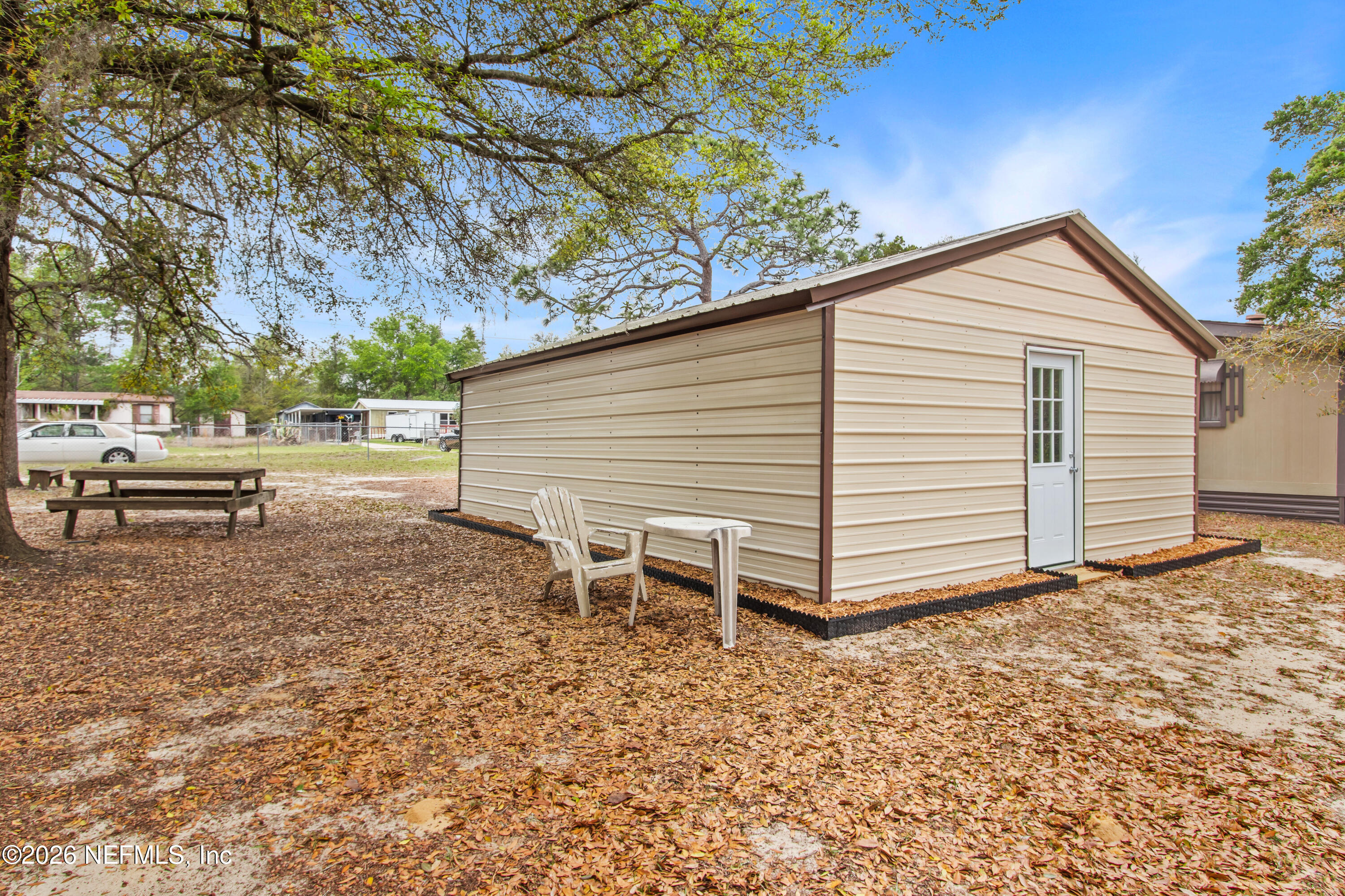 206 Anthony Avenue Interlachen, FL 32148 - Photo 10 of 32 a backyard of a house with a table and chair