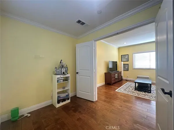 a view of a bedroom with furniture and windows