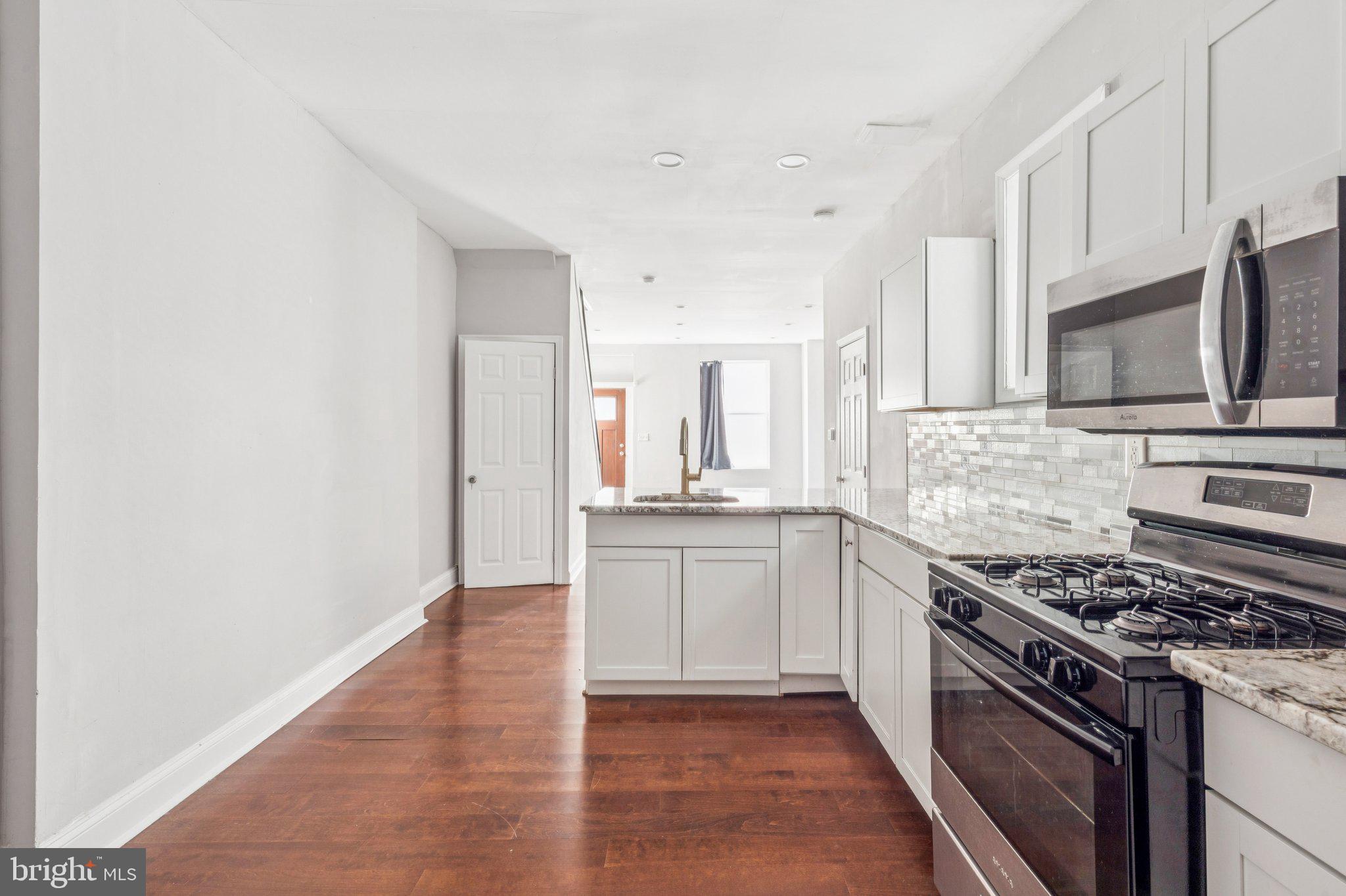 a kitchen with stainless steel appliances granite countertop a stove and a sink