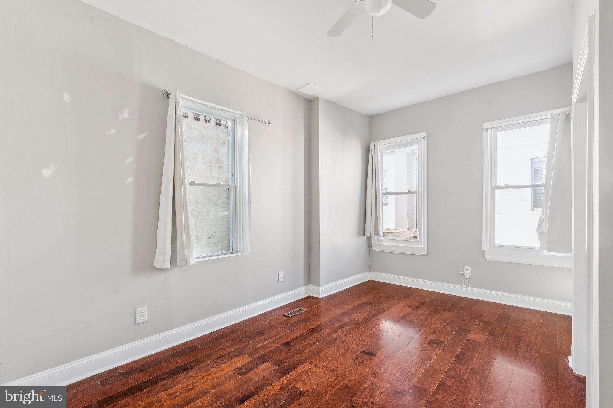 1632 North Dover Street Philadelphia, PA 19121 - Photo 15 of 23 an empty room with wooden floor and windows