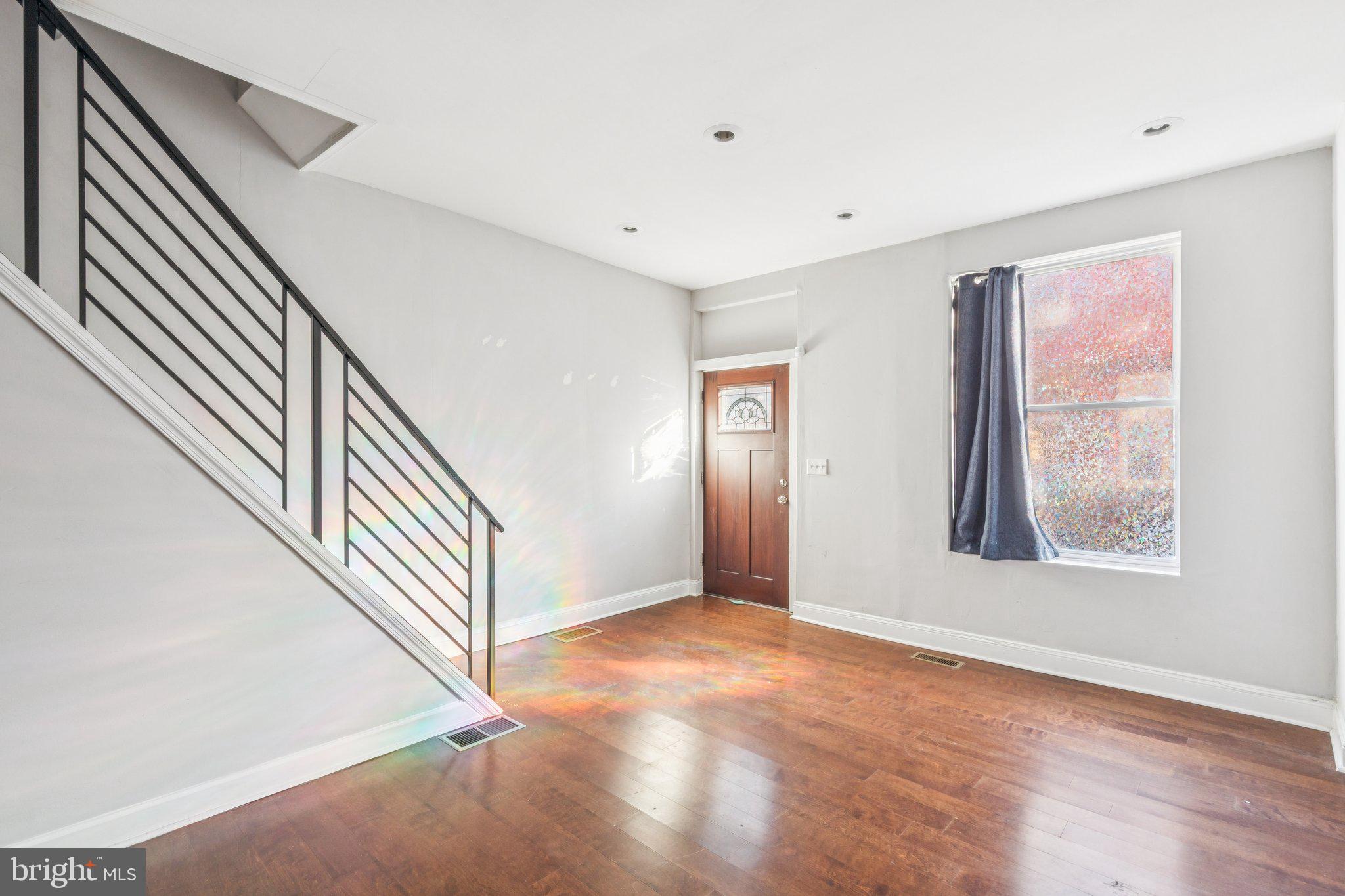 1632 North Dover Street Philadelphia, PA 19121 - Photo 7 of 23 wooden floor in an empty room with a window