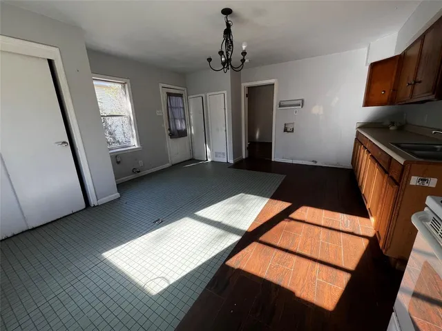 a view of an empty room and wooden floor