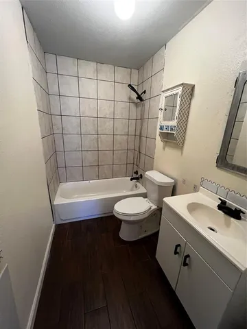 a bathroom with a sink a toilet a mirror and shower