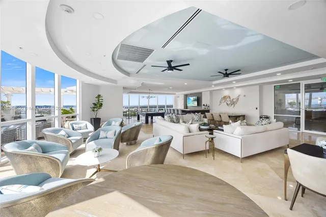 a living room with fireplace furniture and a large window