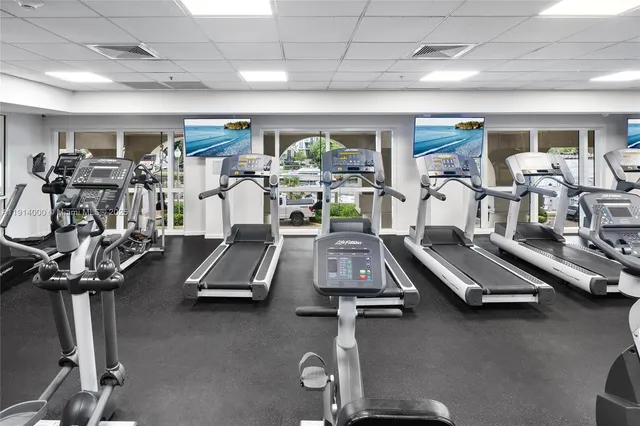 a room with gym equipment and windows