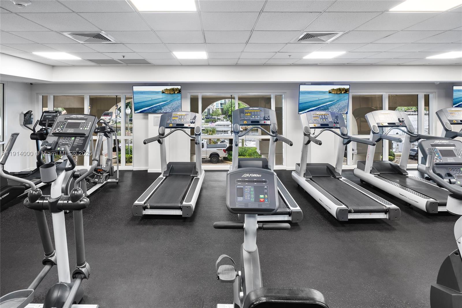 511 Southeast 5th Avenue, Unit 2209 Fort Lauderdale, FL 33301 - Photo 6 of 18 a room with gym equipment and windows