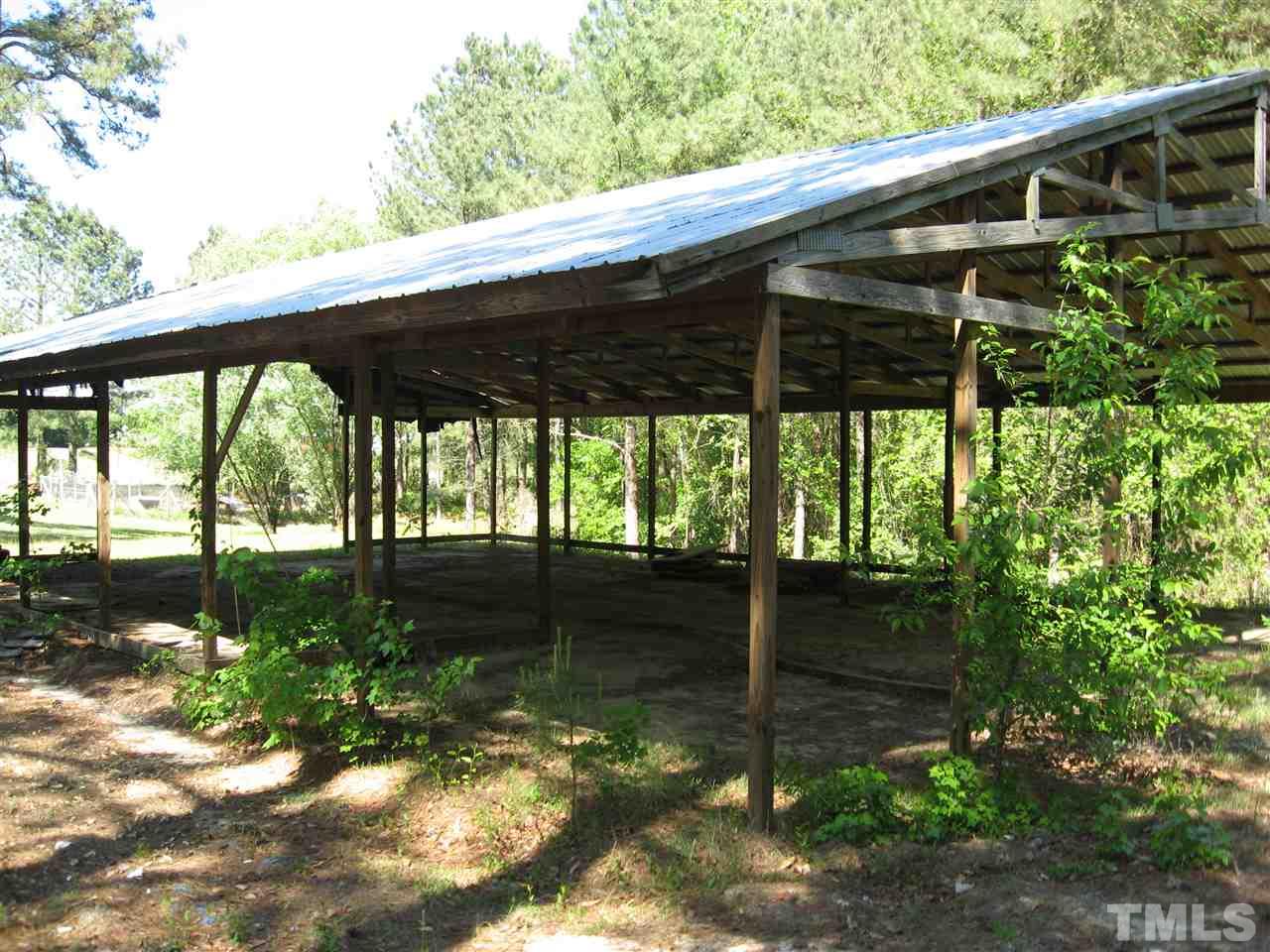 1445 L L Cooper Road Cameron, NC 28326 - Photo 23 of 25 a backyard of a house with a large window table and chairs