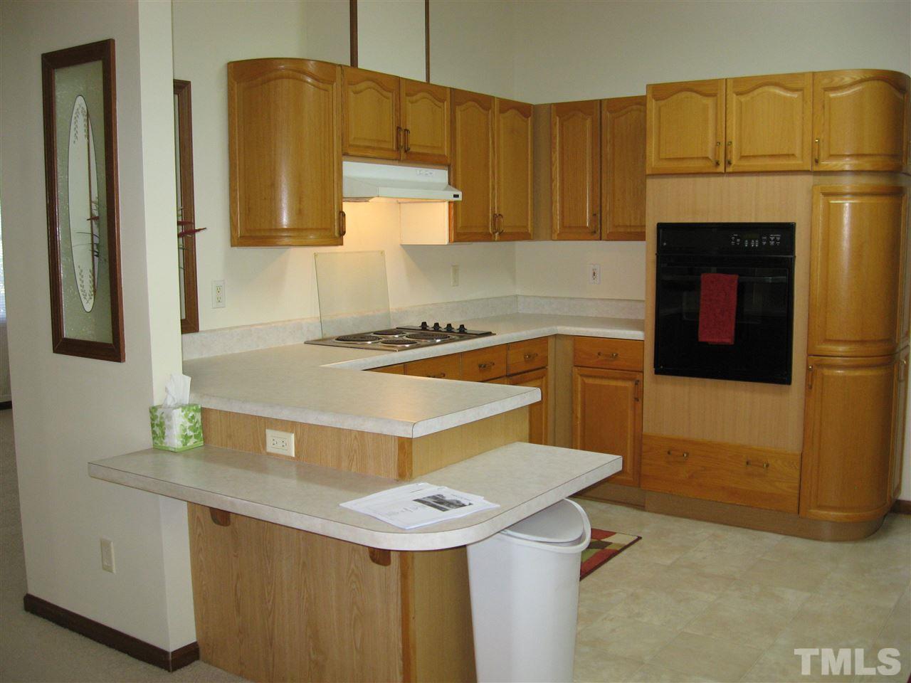 1445 L L Cooper Road Cameron, NC 28326 - Photo 5 of 25 a kitchen with stainless steel appliances a sink a refrigerator and cabinets