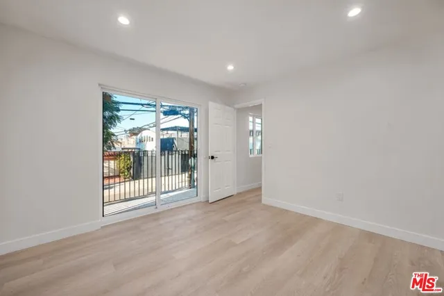 a view of a room with wooden floor and sliding door