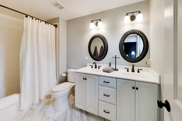 a bathroom with a toilet a sink and a mirror