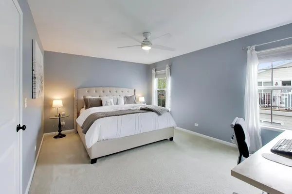 a bedroom with a bed and a desk