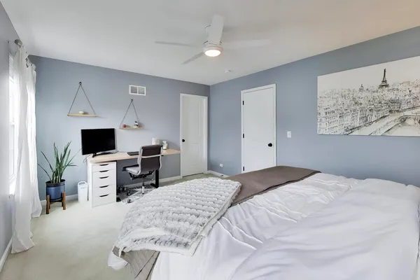 a bedroom with a large bed and a flat screen tv