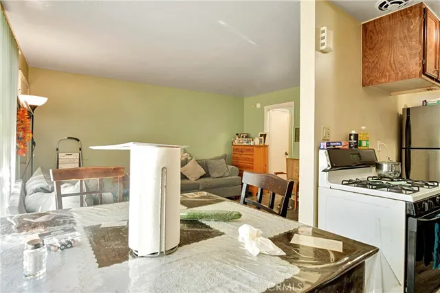 a kitchen with a refrigerator and a stove top oven
