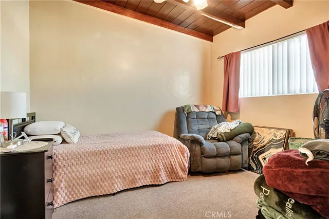 a bedroom with bed and a window