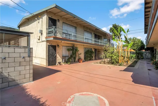 a backyard of a house with potted plants