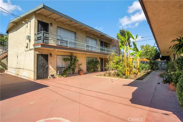 a view of a house with potted plants