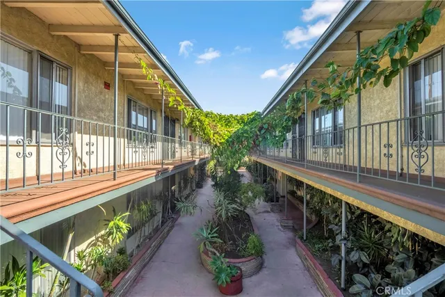 a balcony with wooden floor and outdoor seating