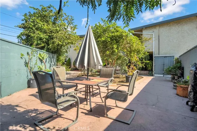 a view of a patio with table and chairs and potted plants
