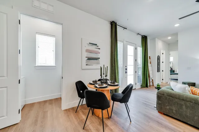 a dining room with furniture and wooden floor