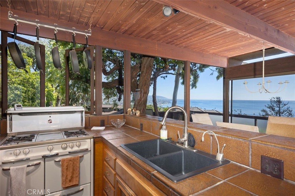 394 Pinecrest Drive Laguna Beach, CA 92651 - Photo 17 of 41 a kitchen with stainless steel appliances granite countertop a sink stove and cabinets