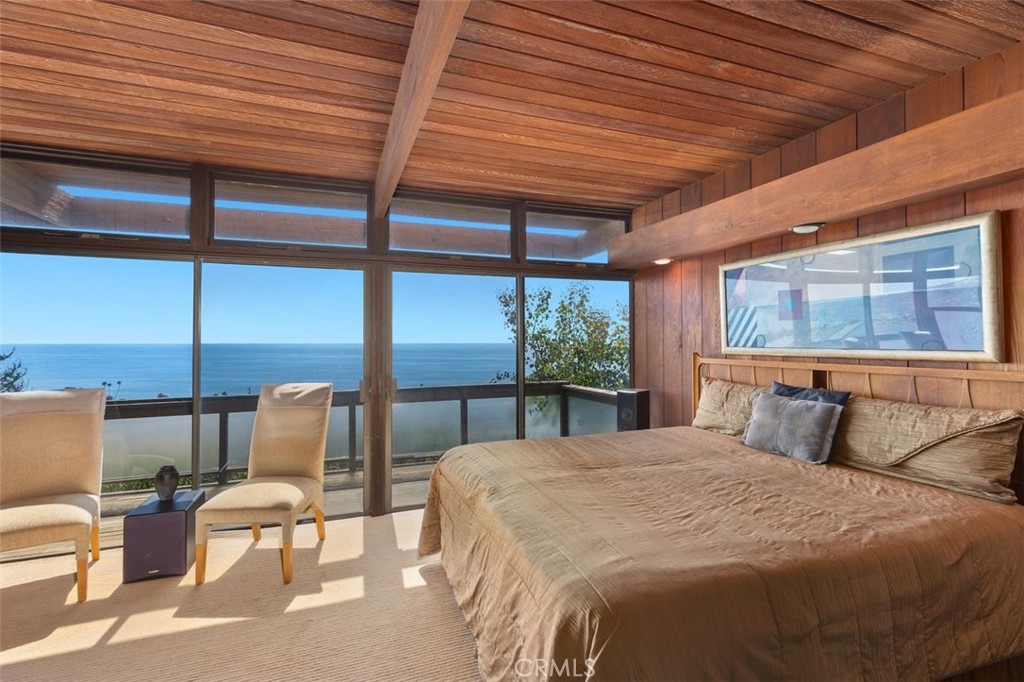394 Pinecrest Drive Laguna Beach, CA 92651 - Photo 22 of 41 a bedroom with a bed a large window with balcony view