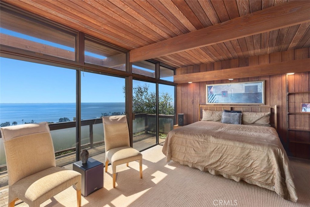 394 Pinecrest Drive Laguna Beach, CA 92651 - Photo 23 of 41 a bedroom with a bed a large window with table and chairs