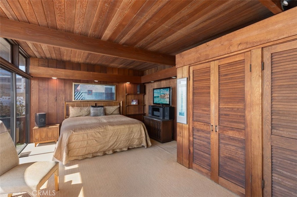 394 Pinecrest Drive Laguna Beach, CA 92651 - Photo 24 of 41 a bedroom with a bed and a dresser