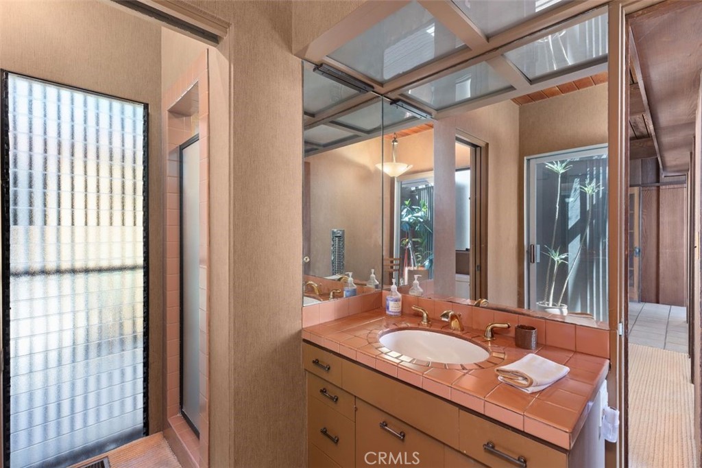 394 Pinecrest Drive Laguna Beach, CA 92651 - Photo 27 of 41 a bathroom with a granite countertop sink mirror and double