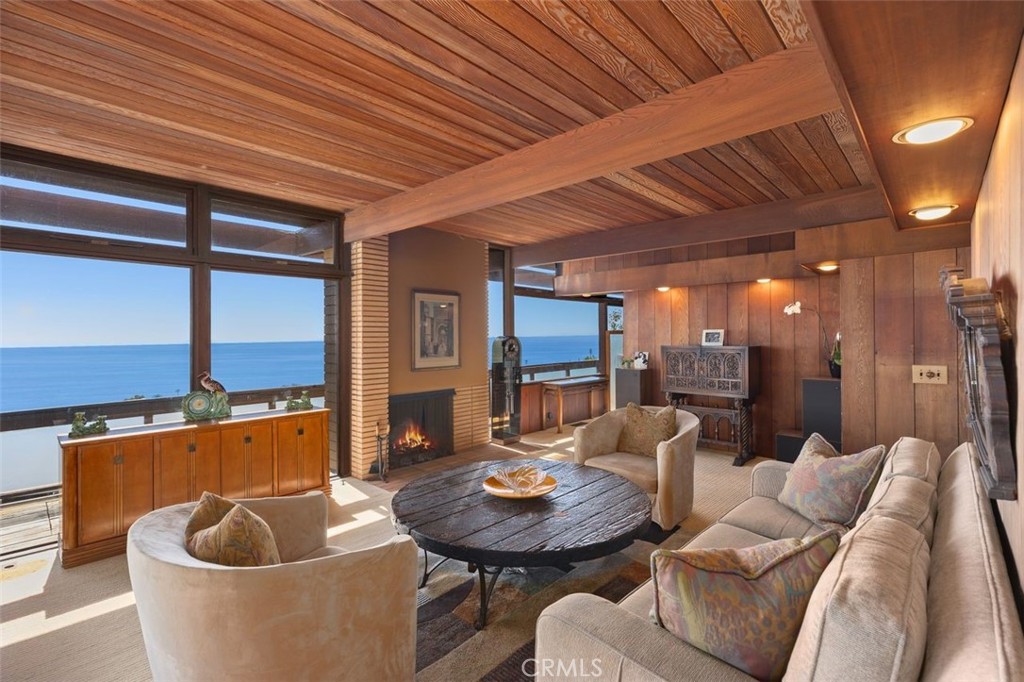 394 Pinecrest Drive Laguna Beach, CA 92651 - Photo 10 of 41 a living room with furniture a fireplace and a table