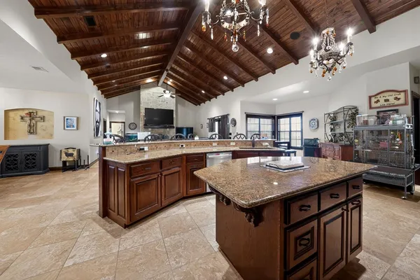 a kitchen with a stove a counter space a sink and cabinets