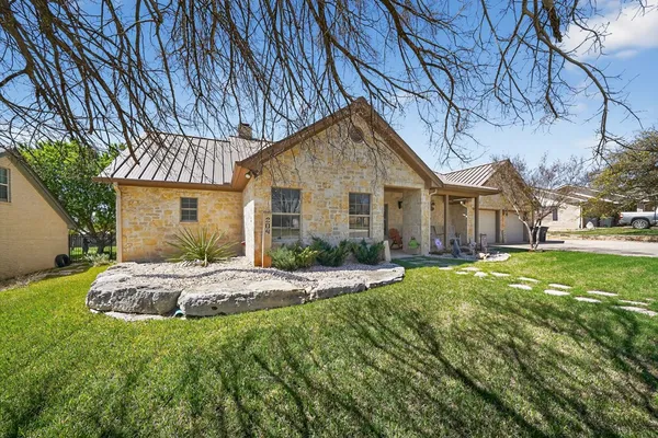a front view of a house with a garden