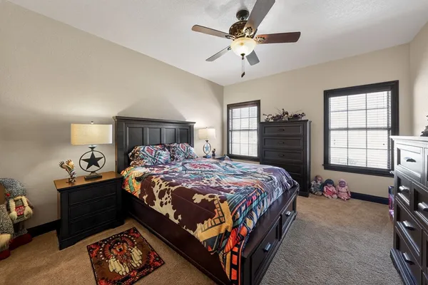 a bedroom with a bed and a television