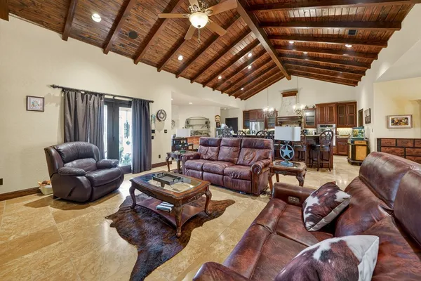 a living room with furniture ceiling fan and a rug