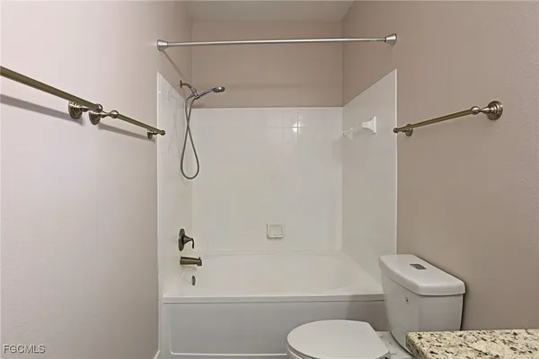 a bathroom with a toilet and shower