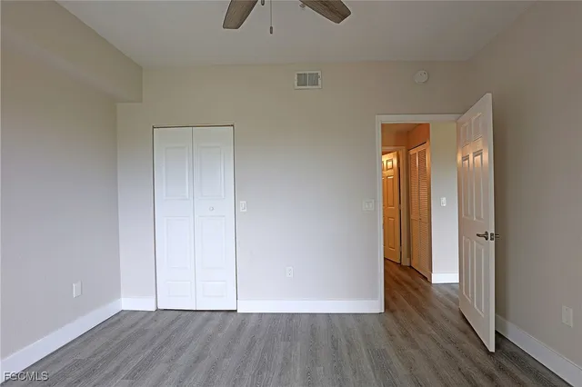 a view of an empty room and wooden floor