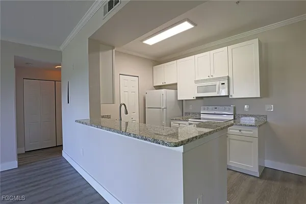 a kitchen with stainless steel appliances granite countertop a sink and cabinets