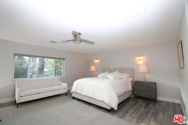 a bedroom with a bed and a night stand