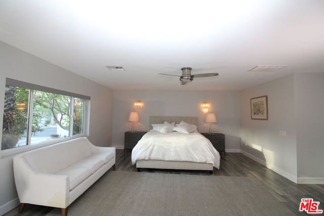 a spacious bedroom with a bed and window