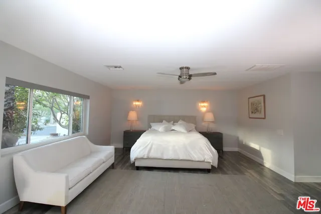 a spacious bedroom with a bed and window