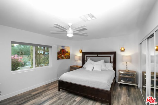 a bedroom with a large bed and a window